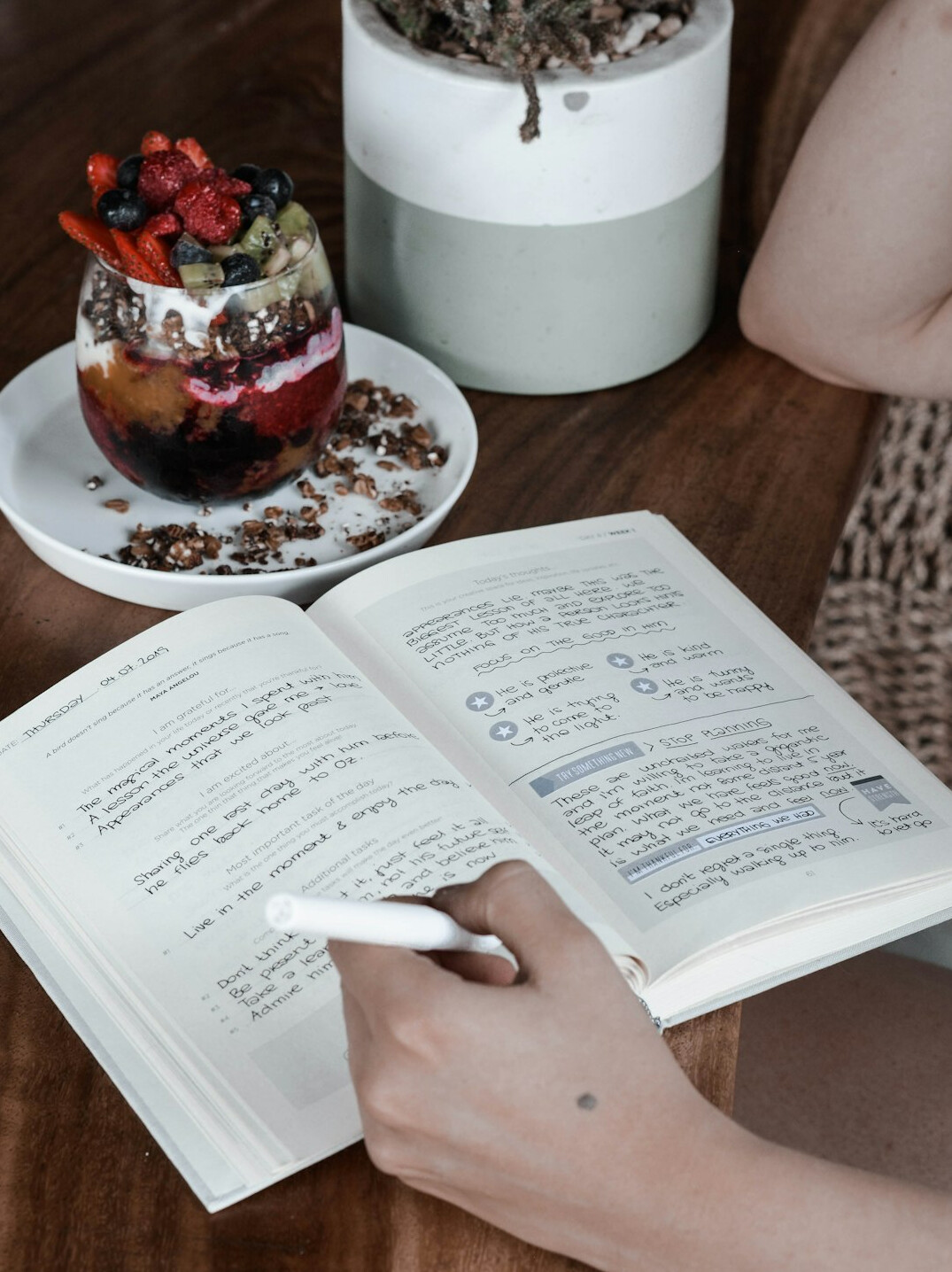 person journaling in cafe